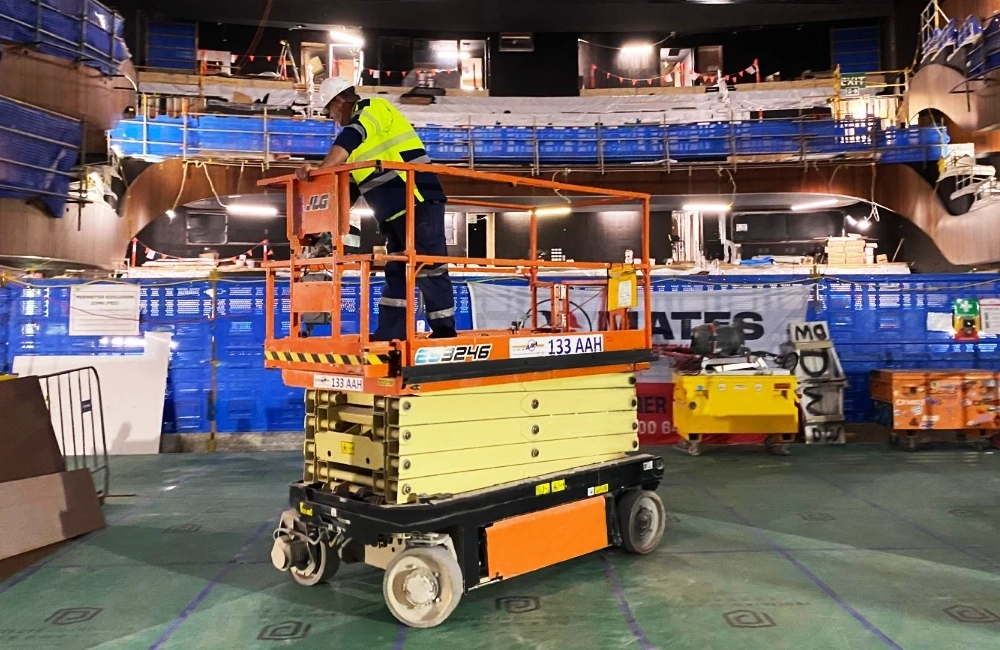 Image of a scissor lift working on a large ship that was hired from AAH Australia