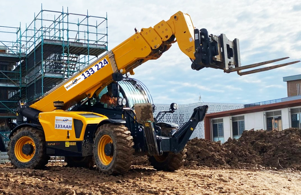 image shows a telehandler hired from AAH working on a muddy Australian construction site