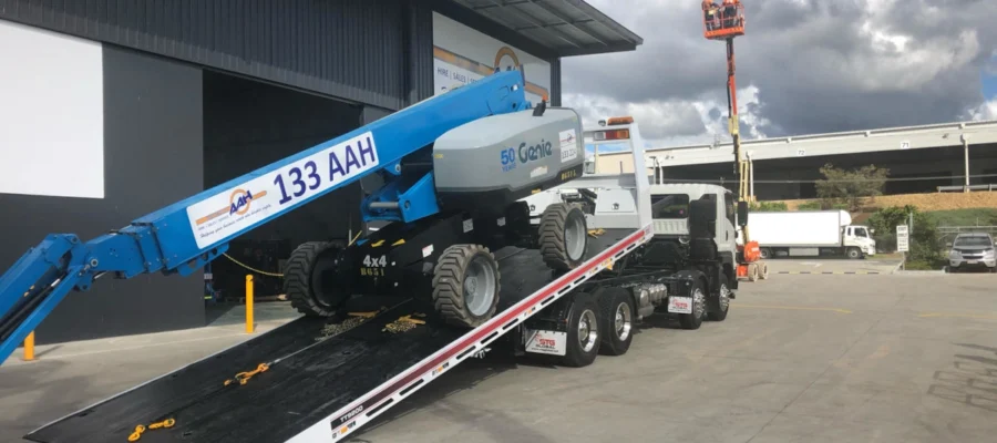 a boom lift hired from AAH being unloaded from a truck